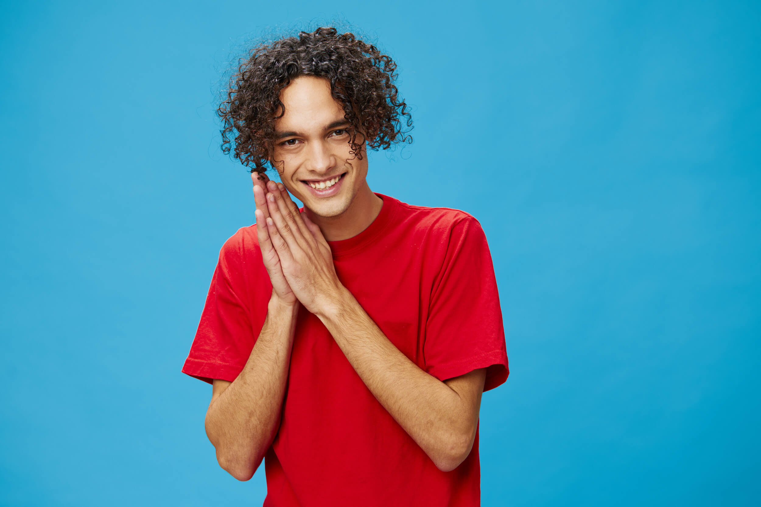 jeune homme se frotte les mains en souriant